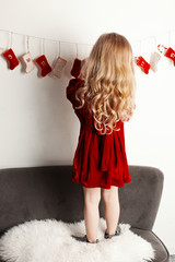 Little girl in red dress with advents calendar - 304038699