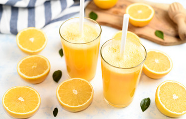Glass of freshly squeezed orange juice and slices of orange fruit isolated on white background