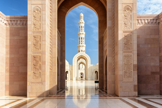 View of minaret through arches of Sultan Qaboos Grand Mosque