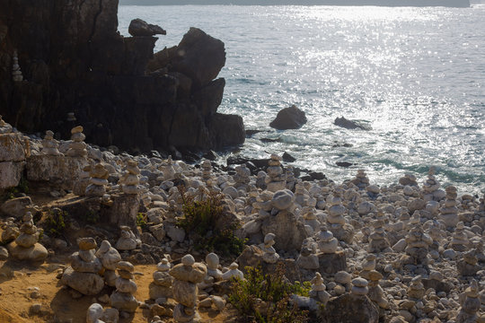 Beach with stacks of rocks called a cairns. Peniche Portugal