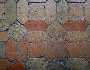 Ancient stone floor in stones with warms tones