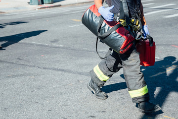 Unrecognizable firefighter working on a New York street