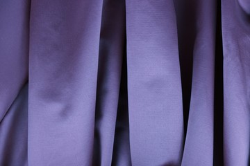 Lilac satin is draped with vertical soft pleats, background
