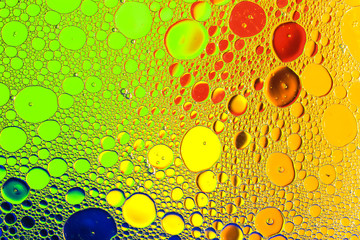 Oil and water with color background creating dreamy smooth diffraction