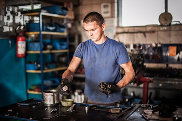 Car mechanic working in auto vulcanizing and vehicle service workshop