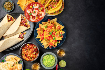 Mexican food, many dishes of the cuisine of Mexico, flat lay, top shot on a black background with a...