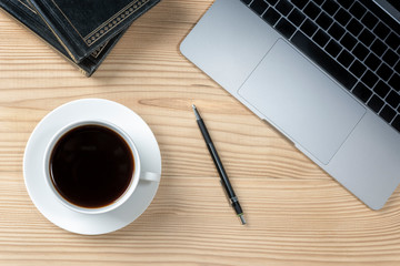 office table with notebook, computer keyboard, pen, cup of americano hot coffee. copy space
