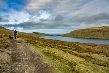 Unidentified tourists hikes in Sorvagsvatn lake over, Faroe Islands