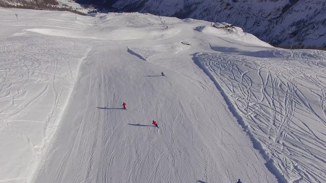 Snowy Ski Resort in Alps. Beautiful drone footage of professional Swiss skiers in the alpine region of Ticino.