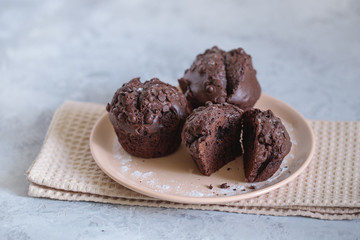 Chocolate muffins on a plate, close up. Space for text. Fresh bakery.