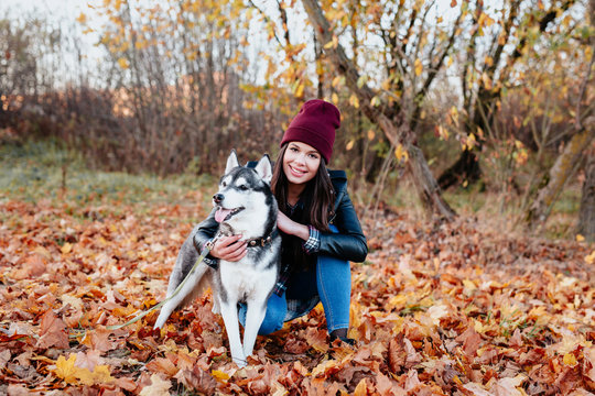 Image of young girl with her dog husky outdoor