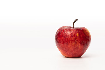 Isolated one red apple with drops on white background.