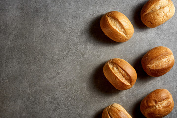 Homemade cakes. Small freshly baked buns on a gray stone surface. Top view.