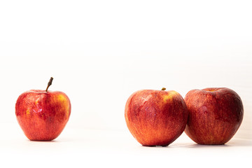 Red apple with drops isolated on white.
