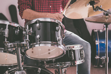 Plakat Caucasian man playing drums, closed up