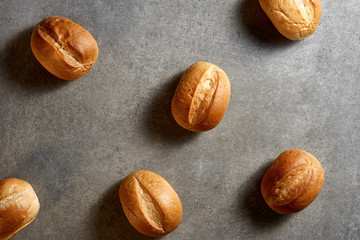 Fresh buns on a gray stone surface. Top view.
