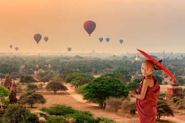 Novic buddhis monk stood watching the balloon  in  the area of Bagan pagoda.