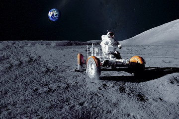 Astronaut near the moon rover on the moon. With land on the horizon. Elements of this image were...