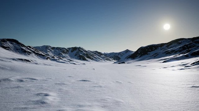 Aerial Landscape of snowy mountains and icy shores in Antarctica