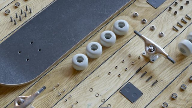 Countless disassembled skateboard parts laying on a wooden floor exposition 4KHD