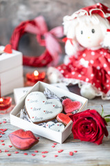 Cookies or gingerbread cookies in a gift box with a red ribbon on a wooden table. Valentine's Day.