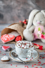 Cookies or gingerbread cookies in a gift box with a red ribbon on a wooden table. Valentine's Day.