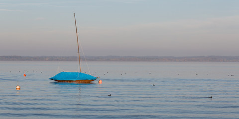CHIEMSEE, BAVARIA / GERMANY - October 23, 2019: Panorama of sailboat anchoring on Lake Chiemsee...