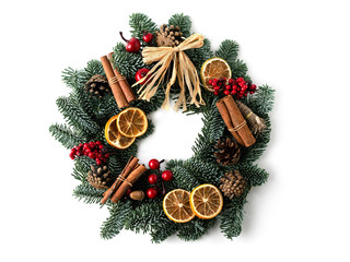 A traditional green christmas wreath isolated with dry orange slice, cinnamon sticks as a decoration.