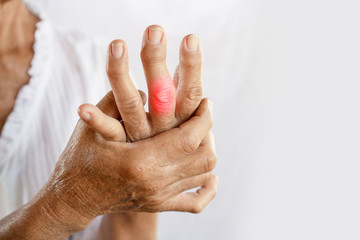 Asian woman hand suffering from joint pain with gout in finger - obrazy, fototapety, plakaty