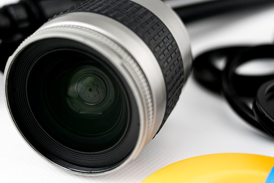 Close-up of shutter and lens of a photo camera lens, on white background
