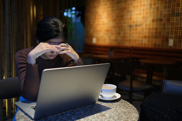 Feeling tired and stressed. Royalty high-quality free stock photo image of young and beautiful asian businesswoman stress with tired eyes, headache, feeling fatigue, overloaded with computer work late
