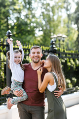 Fototapeta premium Young family with daughter have fun outside in the park.