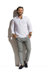 Relaxed Elegant Man Is Standing With Hands In Pockets.