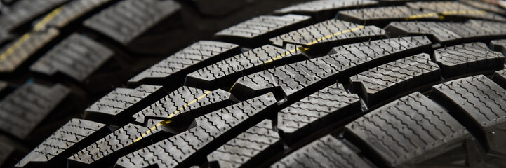 Protector close-up of new winter tires. on black background