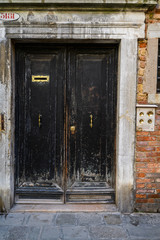 Fototapeta na wymiar Venice, Italy. Antique black wooden door.