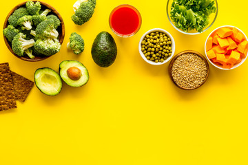 Healthy food. Vegatables and fruits on yellow background top view frame copy space