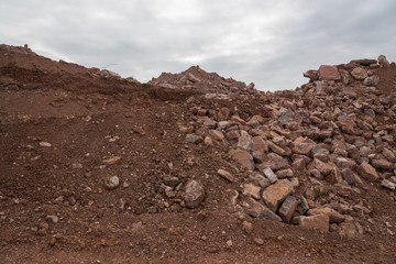 Close-up of hills stacked with dirt and stone engineering materials on the construction site