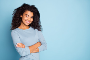 Photo of cheerful cute nice pretty charming youngster with arms crossed smiling toothily near empty...