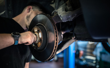 Wheel bearing repair at auto service/garage or workshop by mechanic