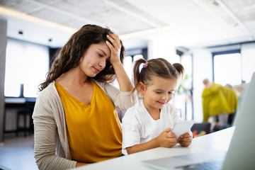 People, children, technology and addiction concept. Little girl with smartphones