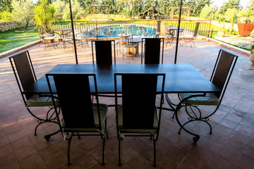 table and chairs in a garden, photo as background