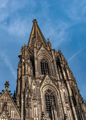 Fototapeta na wymiar Gothic Cathedral Church of Saint Peter in Cologne, Germany on a sunny day. Beautiful cityscape with details of the towers, arches and windows stained glass