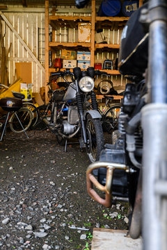 10.10.2019 Helsinki, Finland - open garage space, with vintage motorcycle in storage on shelving.