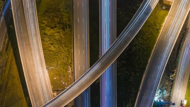 aerial shot view of traffic on freeway interchange at night. 4K UHD timelapse background