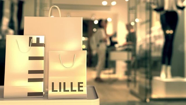 Shopping bags with Lille caption against blurred store entrance. Shopping in France related 3D animation