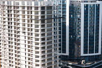 Bulidings cityscape with high tower cranes and old houses rising new city