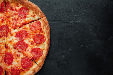 Pepperoni pizza on stone background with copy space for your text, ready to eat.