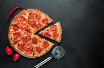 Pepperoni pizza on stone background with copy space for your text, ready to eat.