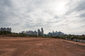 Fototapeta na wymiar City building dirt road horizon road landscape