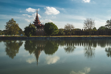 Palace wall with trees reflecting in the water - Mandalay Palace, Myanmar